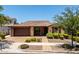 Charming single-story brick home with manicured landscaping, tiled roof, and a two-car garage at 10618 E Kinetic Dr, Mesa, AZ 85212