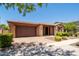 Charming single-story brick home with manicured landscaping, tiled roof, and a two-car garage at 10618 E Kinetic Dr, Mesa, AZ 85212