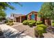 Charming single-story brick home with manicured landscaping and a two-car garage at 10618 E Kinetic Dr, Mesa, AZ 85212