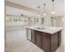 Modern kitchen with dark wood cabinets, a large center island and an open concept at 10618 E Kinetic Dr, Mesa, AZ 85212