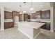 Bright kitchen featuring dark cabinetry, a large center island, and modern appliances at 10618 E Kinetic Dr, Mesa, AZ 85212