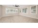 Spacious living room bathed in light with ample windows and neutral color palette at 10618 E Kinetic Dr, Mesa, AZ 85212