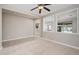 Living room featuring an open concept, neutral colors, and a view into the kitchen at 10618 E Kinetic Dr, Mesa, AZ 85212