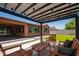 Covered pergola with stylish lighting, creating an inviting outdoor entertainment and seating area at 10618 E Kinetic Dr, Mesa, AZ 85212