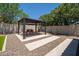 A Backyard pergola featuring desert landscaping, concrete pavers and seating at 10618 E Kinetic Dr, Mesa, AZ 85212