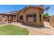 This home features a well-maintained backyard, complete with a pergola, built-in BBQ, and artificial turf at 10910 E Sebring Ave, Mesa, AZ 85212