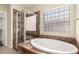 Large soaking tub next to walk-in shower in spacious bathroom at 10910 E Sebring Ave, Mesa, AZ 85212