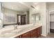 Primary bathroom featuring double sinks, large mirror, and a walk-in shower at 10910 E Sebring Ave, Mesa, AZ 85212