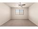 Bedroom features carpet flooring, ceiling fan, and window at 10910 E Sebring Ave, Mesa, AZ 85212