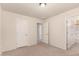 Neutral-toned bedroom featuring carpet, three doorways and a light fixture at 10910 E Sebring Ave, Mesa, AZ 85212