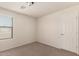 Neutral-toned bedroom featuring carpet, window with blinds, and a light fixture at 10910 E Sebring Ave, Mesa, AZ 85212