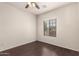 Cozy room featuring hardwood floors, a ceiling fan and a window at 10910 E Sebring Ave, Mesa, AZ 85212