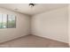 Bedroom features carpet flooring, a window, and ceiling light at 10910 E Sebring Ave, Mesa, AZ 85212