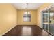 The dining room features a view of the back yard and sliding glass door access to the patio at 10910 E Sebring Ave, Mesa, AZ 85212