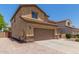 Side view of a two-story home featuring a long drive and a convenient two-car garage at 10910 E Sebring Ave, Mesa, AZ 85212