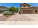 Two-story home featuring a long drive and a convenient two-car garage at 10910 E Sebring Ave, Mesa, AZ 85212