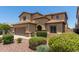 Charming desert home featuring low-maintenance landscaping, a spacious driveway, and an attached two-car garage at 10910 E Sebring Ave, Mesa, AZ 85212