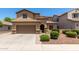 Inviting two-story home boasts a desert-landscaped front yard and a convenient two-car garage at 10910 E Sebring Ave, Mesa, AZ 85212