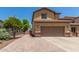Two-story home featuring a long drive and a convenient two-car garage at 10910 E Sebring Ave, Mesa, AZ 85212