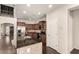 Modern kitchen with stainless steel appliances, granite counters, and an island with a sink at 10910 E Sebring Ave, Mesa, AZ 85212