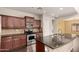 An open kitchen features dark countertops, modern appliances and stainless steel sink at 10910 E Sebring Ave, Mesa, AZ 85212