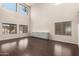 Spacious living room features high ceilings, plenty of natural light and dark wood-look floors at 10910 E Sebring Ave, Mesa, AZ 85212