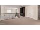 Loft space with carpet flooring, railing, and built-in bookcase at 10910 E Sebring Ave, Mesa, AZ 85212
