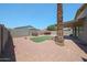 Low maintenance backyard with rock landscaping, artificial turf, plants, and a privacy fence at 11548 W Cottonwood Ln, Avondale, AZ 85392