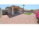 Spacious backyard featuring a covered patio, gravel, artificial turf, and vibrant bougainvillea at 11548 W Cottonwood Ln, Avondale, AZ 85392