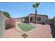 Low maintenance backyard with rock landscaping, artificial turf, flowering bushes, and a patio at 11548 W Cottonwood Ln, Avondale, AZ 85392