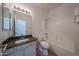 Well-lit bathroom with a modern vanity, mirror, shower-tub combo, and toilet at 11548 W Cottonwood Ln, Avondale, AZ 85392