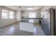 Modern kitchen with stainless steel appliances, gray countertops, and an island at 11548 W Cottonwood Ln, Avondale, AZ 85392