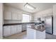 Well-equipped kitchen with stainless steel appliances, gray countertops, and an island at 11548 W Cottonwood Ln, Avondale, AZ 85392