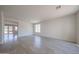 Bright living room featuring wood-look floors and a seamless flow to other living spaces at 11548 W Cottonwood Ln, Avondale, AZ 85392