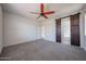 Large bedroom featuring carpet, neutral walls, and a barn door leading to the bathroom at 11548 W Cottonwood Ln, Avondale, AZ 85392