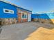 Private backyard featuring unique stone accents and a blue painted exterior with a desert lizard art feature at 1226 W Purdue Ave, Phoenix, AZ 85021