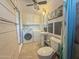 Updated bathroom with laundry with pedestal sink, toilet, and shower with curtain at 1226 W Purdue Ave, Phoenix, AZ 85021