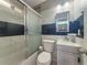 Updated bathroom with marble tile, shower over tub, and modern fixtures at 1226 W Purdue Ave, Phoenix, AZ 85021
