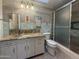 Bathroom with glass shower door and a white vanity with a granite countertop at 1226 W Purdue Ave, Phoenix, AZ 85021