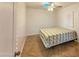 Cozy bedroom featuring a white brick wall, ceiling fan, and natural light at 1226 W Purdue Ave, Phoenix, AZ 85021