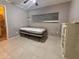 Bedroom with tiled floor, large window, ceiling fan, and a wardrobe, offering comfortable living space at 1226 W Purdue Ave, Phoenix, AZ 85021