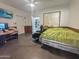 This bedroom offers a ceiling fan, tiled floors, and wood paneling at 1226 W Purdue Ave, Phoenix, AZ 85021