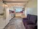View of the kitchen with white cabinets and an adjacent seating area at 1226 W Purdue Ave, Phoenix, AZ 85021
