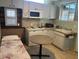 Efficient kitchenette boasts wood-look walls and white cabinets and countertops at 1226 W Purdue Ave, Phoenix, AZ 85021