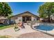 A spacious backyard with a covered patio, fenced pool, and play area, perfect for Gathering fun at 12325 W Berridge Ln, Litchfield Park, AZ 85340