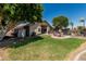 Lush green backyard featuring a play area and a private pool, perfect for outdoor enjoyment at 12325 W Berridge Ln, Litchfield Park, AZ 85340