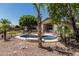 Enjoy a private backyard with a fenced pool, palm trees, and desert landscaping at 12325 W Berridge Ln, Litchfield Park, AZ 85340