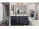 The bathroom features a double sink vanity, a large tub, and a glass-enclosed shower at 12325 W Berridge Ln, Litchfield Park, AZ 85340