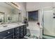 The bathroom features a double sink vanity, a large tub, and a glass-enclosed shower at 12325 W Berridge Ln, Litchfield Park, AZ 85340