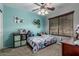 Cozy bedroom featuring teal accent wall, floral bedding, and a ceiling fan at 12325 W Berridge Ln, Litchfield Park, AZ 85340